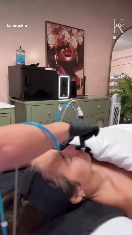 A facial in progress in the KIAMO Skin treatment room, client reclined under an eye mask